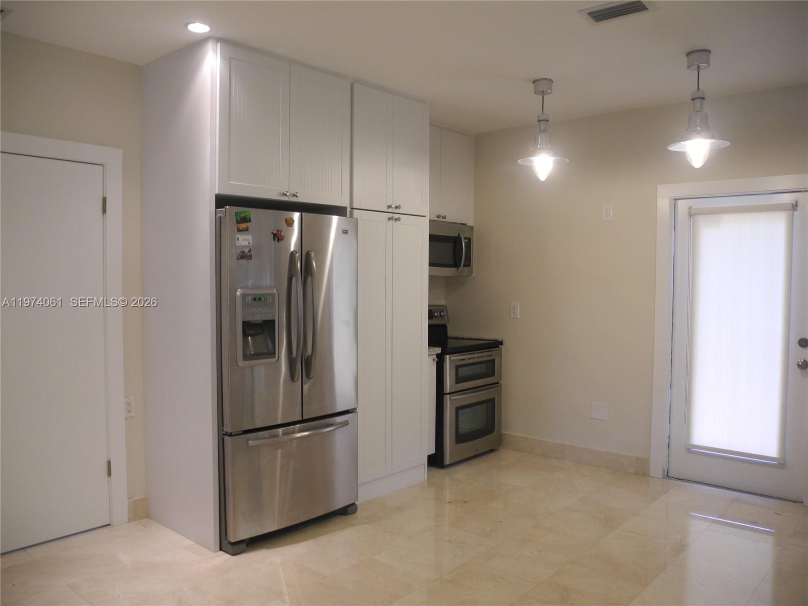 1720 Southwest 22nd Terrace Miami, FL 33145 - Photo 5 of 19 a metallic refrigerator freezer sitting in a kitchen