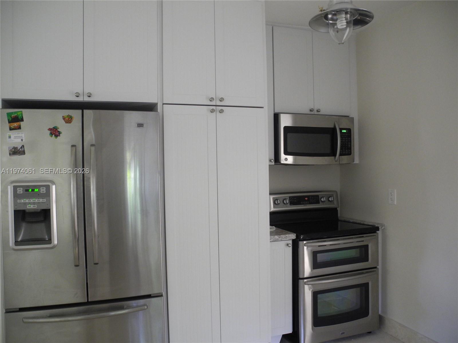 1720 Southwest 22nd Terrace Miami, FL 33145 - Photo 6 of 19 a kitchen with a refrigerator and a stove top oven