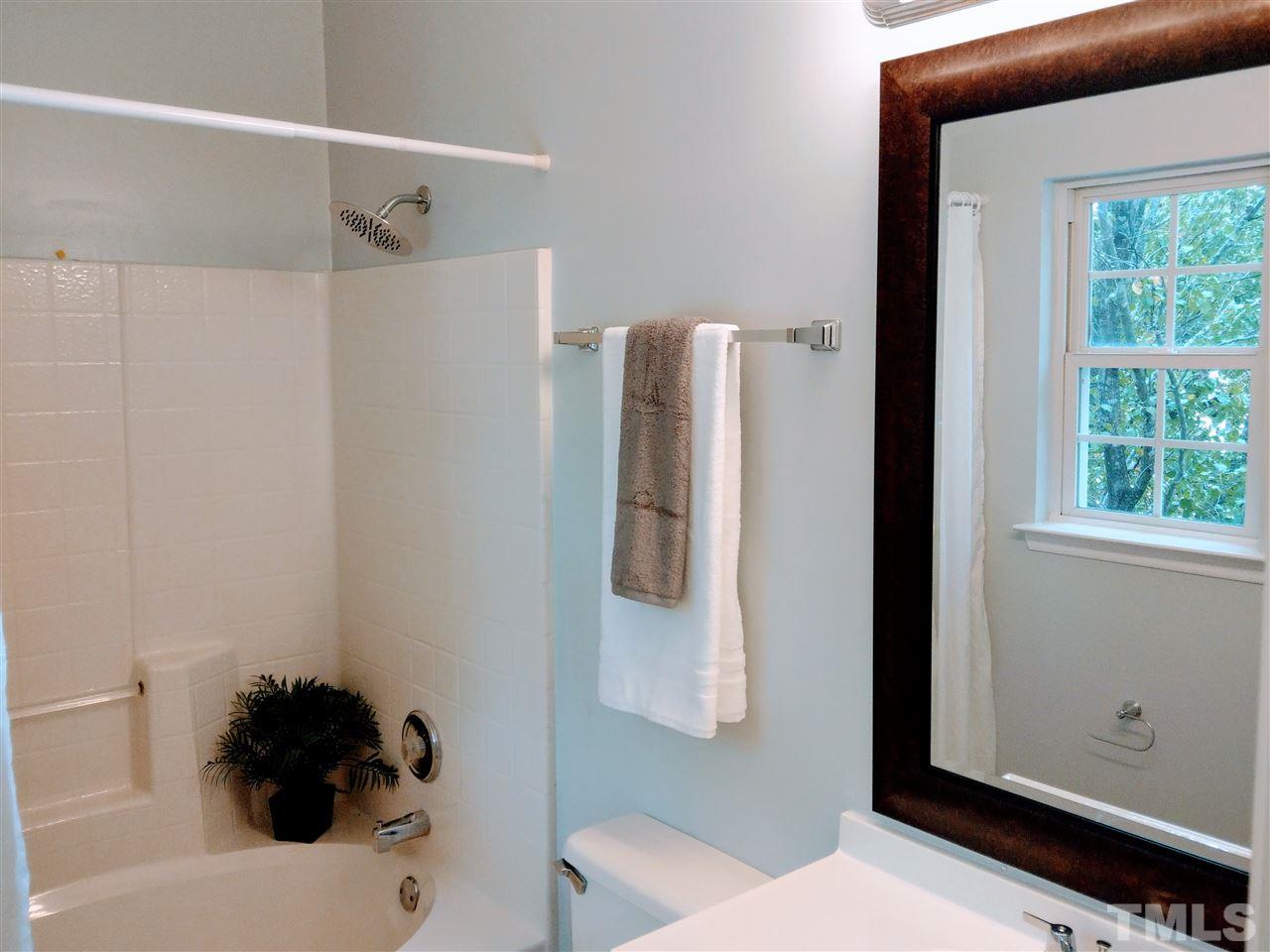 5619 Marthonna Way Raleigh, NC 27616 - Photo 14 of 26 a bathroom with a sink and a mirror