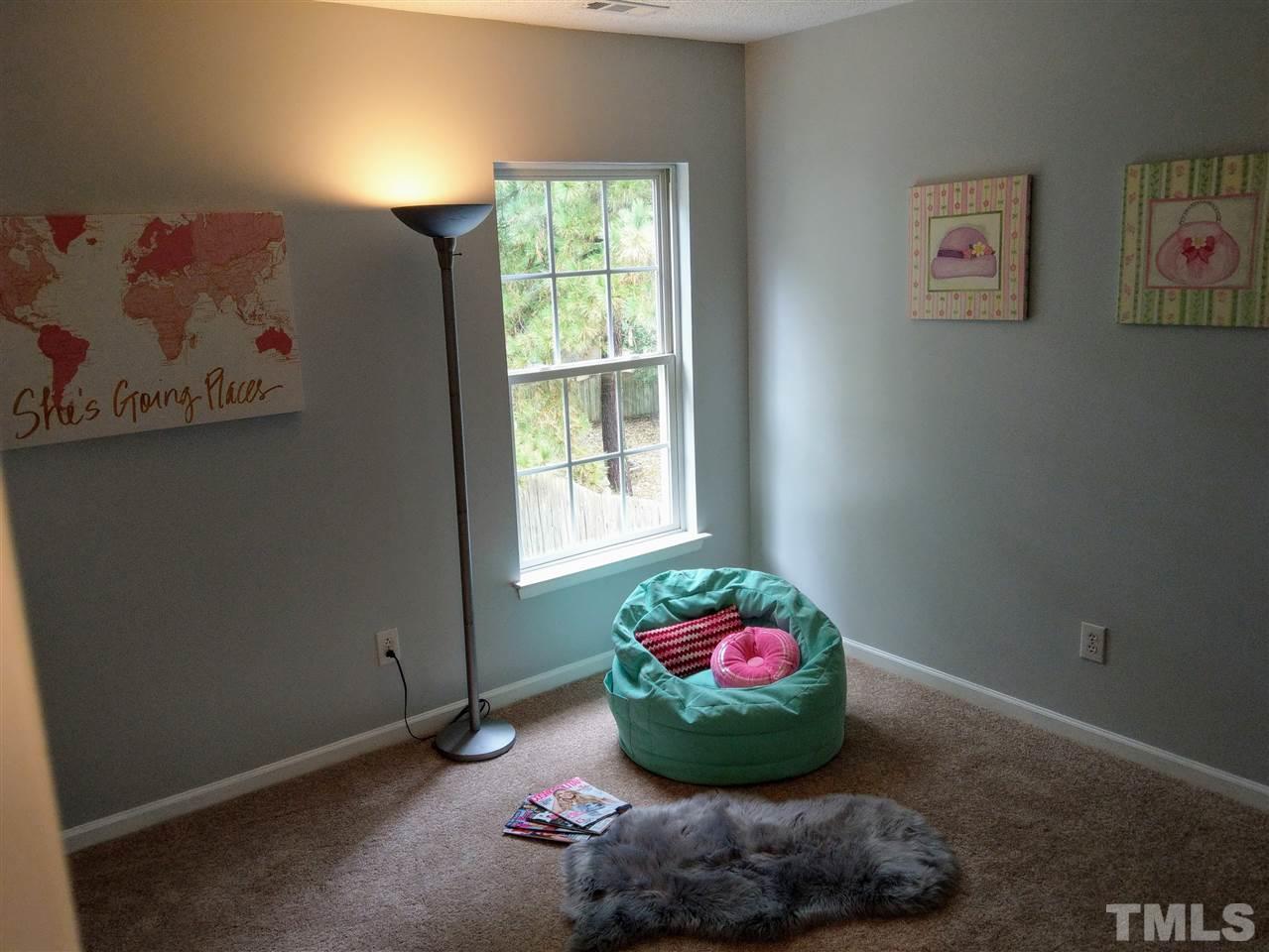 5619 Marthonna Way Raleigh, NC 27616 - Photo 23 of 26 a room with a vase of flowers and a table