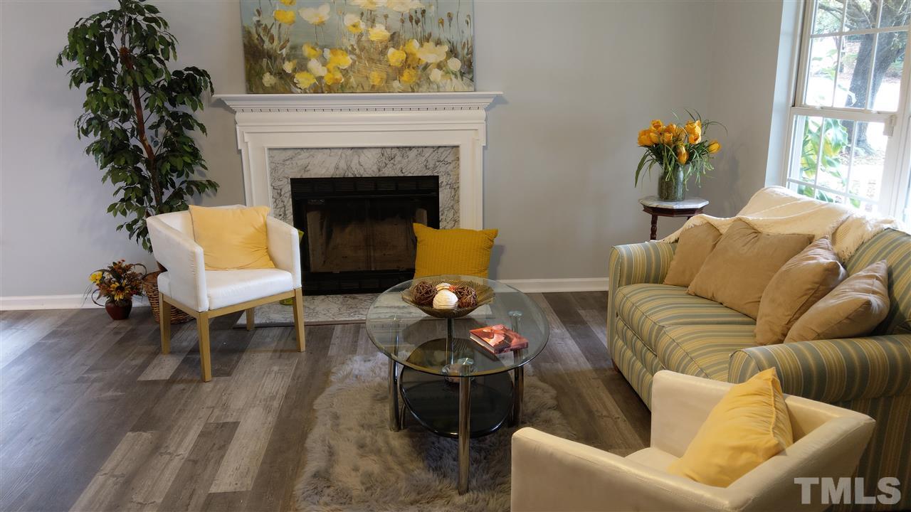 5619 Marthonna Way Raleigh, NC 27616 - Photo 6 of 26 a living room with furniture and a fireplace