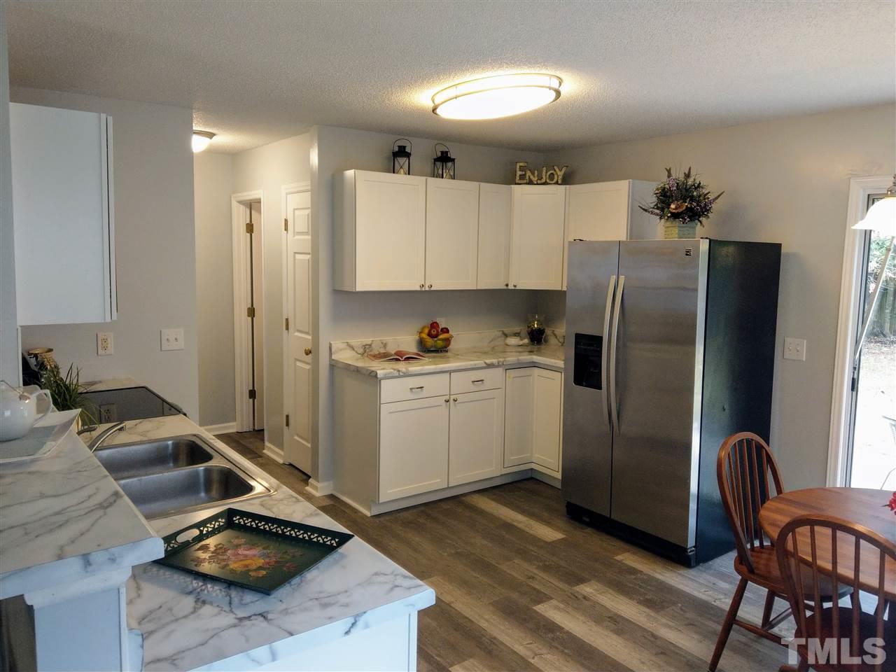 5619 Marthonna Way Raleigh, NC 27616 - Photo 9 of 26 a kitchen with a refrigerator and cabinets