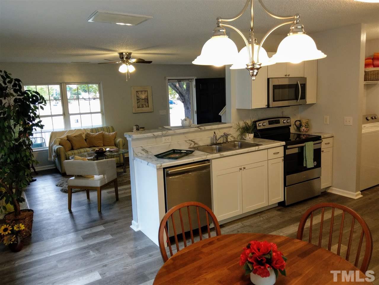 5619 Marthonna Way Raleigh, NC 27616 - Photo 10 of 26 a kitchen with a sink cabinets and a fireplace