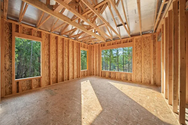 a view of a room with wooden walls and sliding window