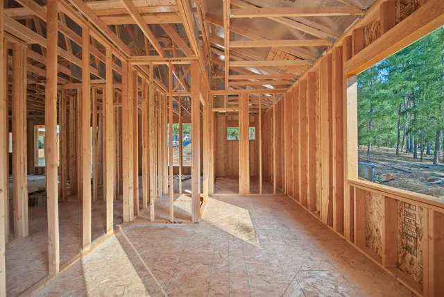 a view of a porch with wooden walls and floor to ceiling window