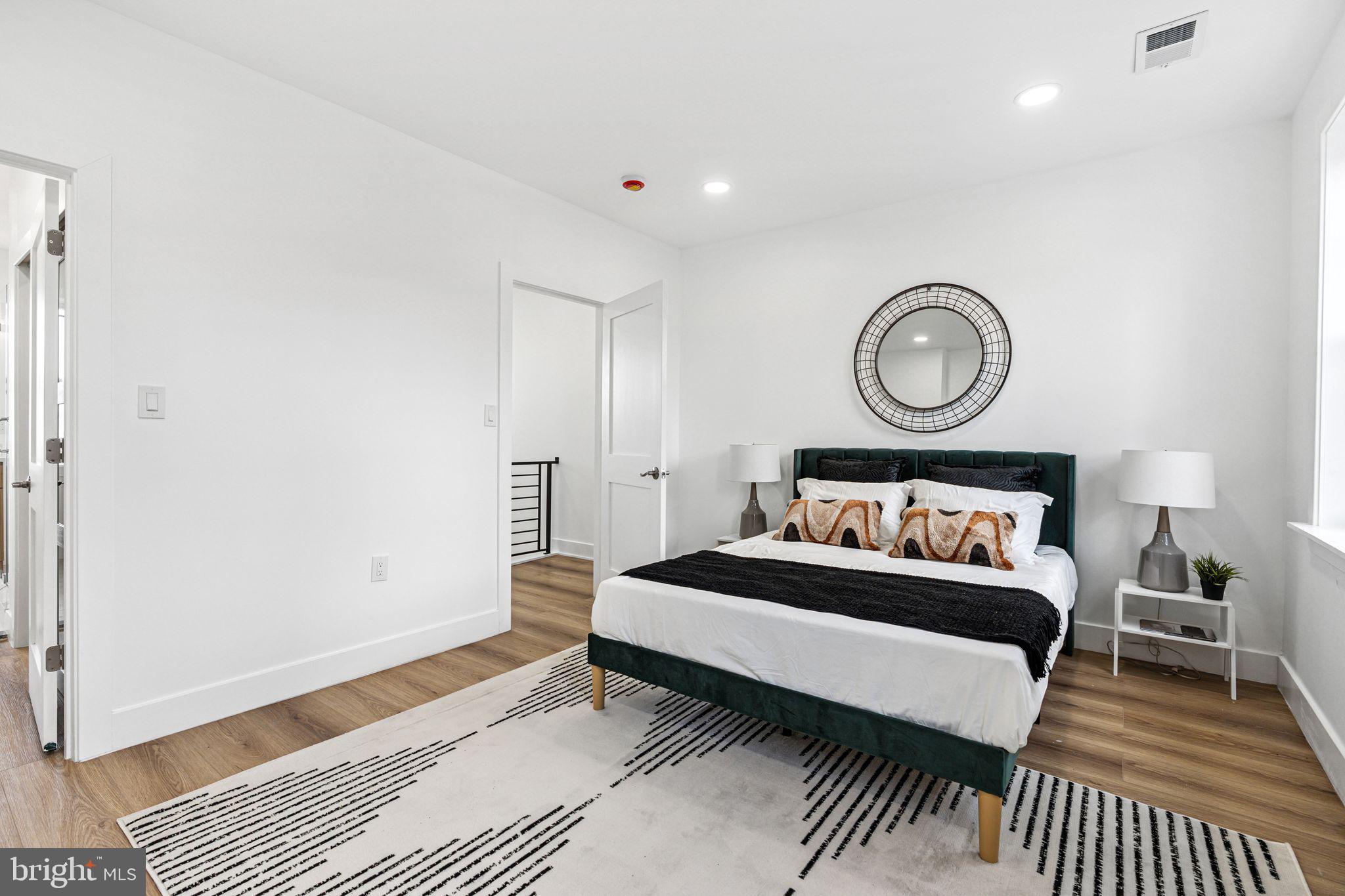 908 Reed Street Philadelphia, PA 19147 - Photo 11 of 33 a bedroom with a bed and a table
