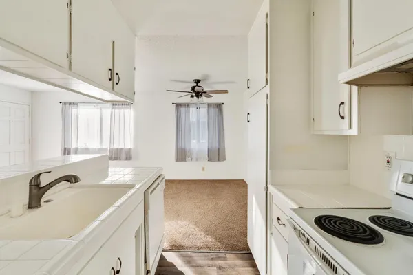 a kitchen with a sink stove and refrigerator