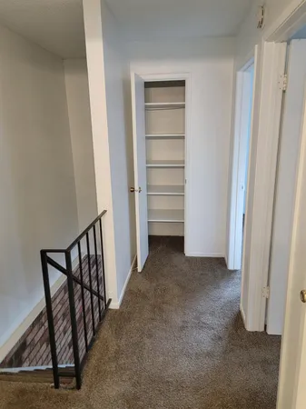 a view of room with stairs and a window