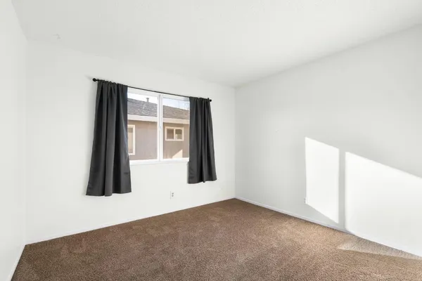 a view of an empty room with windows