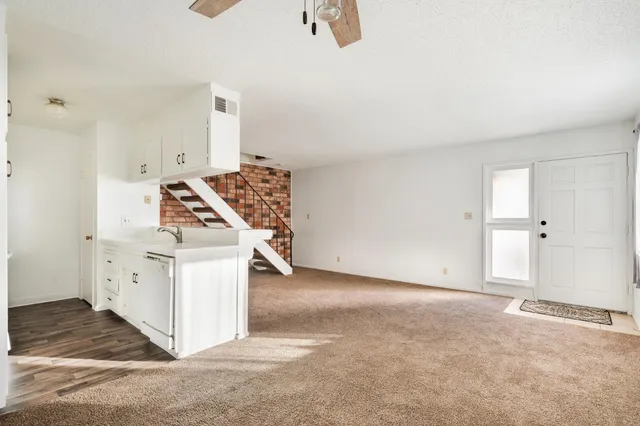 an empty room with windows and pillars