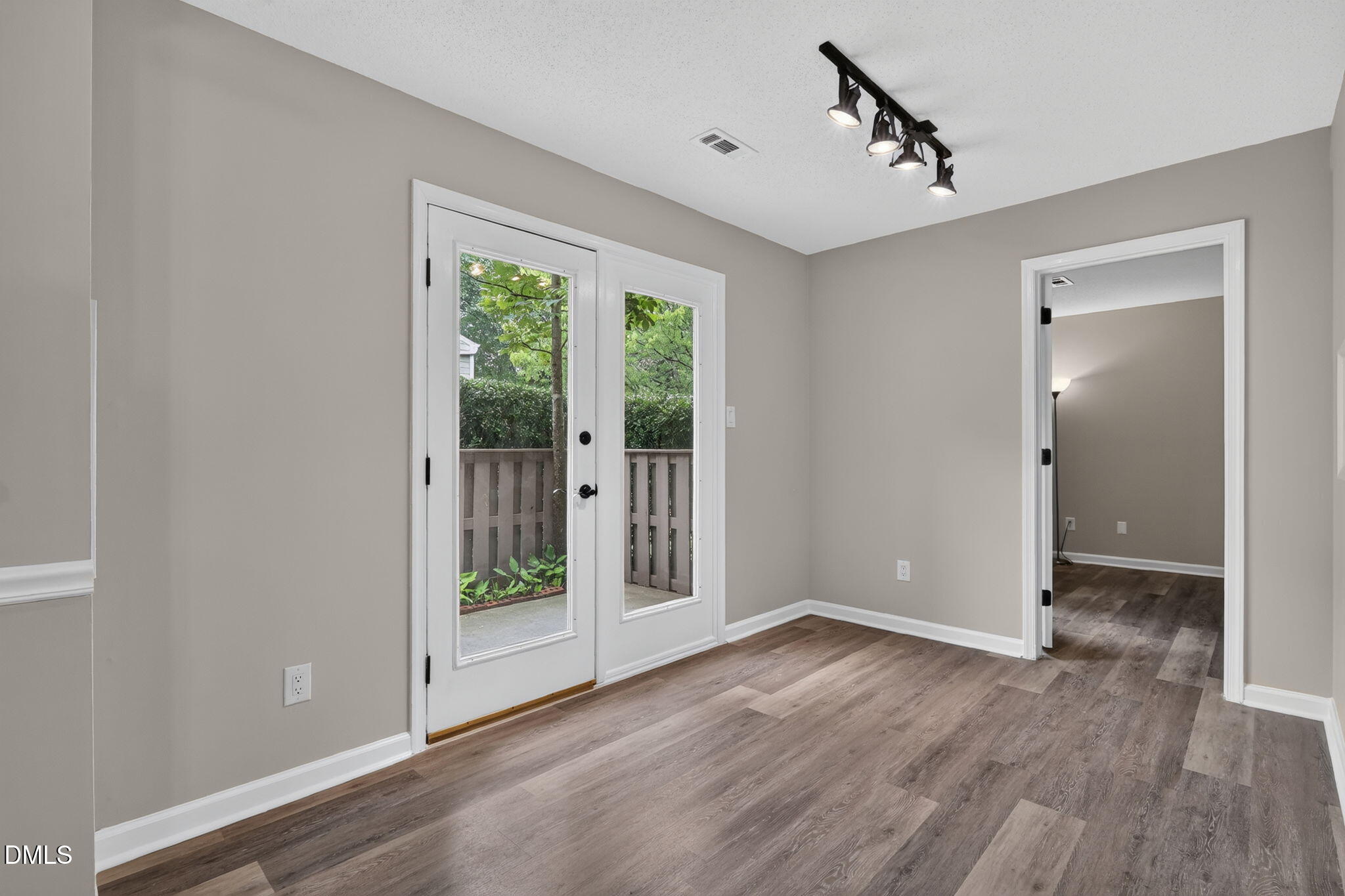 3425 Mill Run Raleigh, NC 27612 - Photo 15 of 40 a view of an empty room with wooden floor and a window