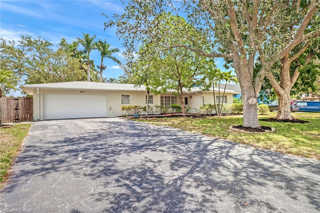 a view of a house with a yard and tree