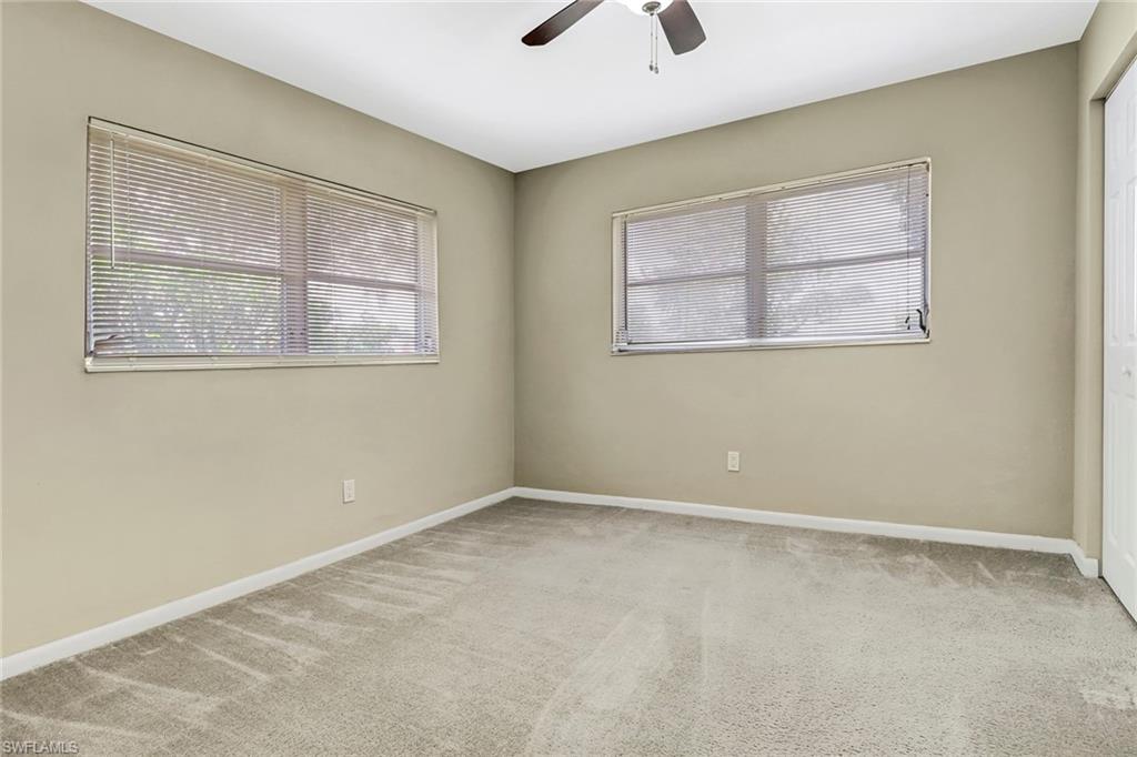 189 Mentor Drive Naples, FL 34110 - Photo 16 of 25 an empty room with windows