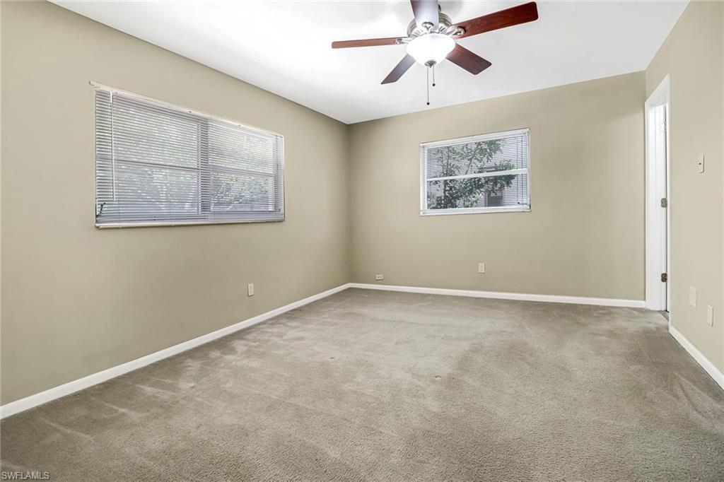 189 Mentor Drive Naples, FL 34110 - Photo 20 of 25 an empty room with windows and fan