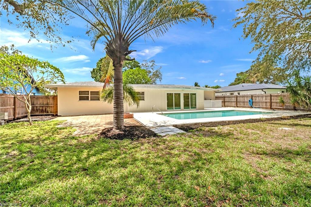189 Mentor Drive Naples, FL 34110 - Photo 2 of 25 a house view with a garden space