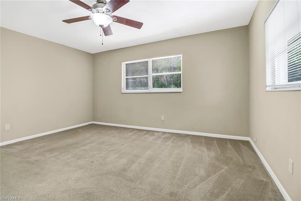 189 Mentor Drive Naples, FL 34110 - Photo 21 of 25 an empty room with a window and a fan