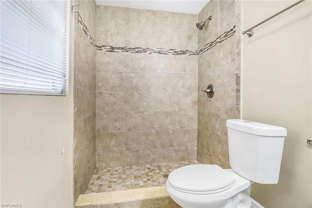 189 Mentor Drive Naples, FL 34110 - Photo 23 of 25 a white toilet sitting next to a shower