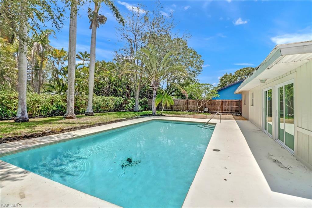 189 Mentor Drive Naples, FL 34110 - Photo 24 of 25 a view of swimming pool with outdoor seating and plants