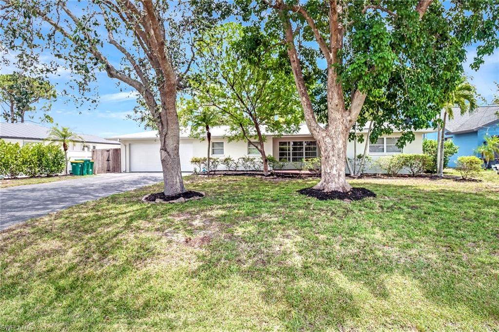 189 Mentor Drive Naples, FL 34110 - Photo 3 of 25 a front view of a house with a yard