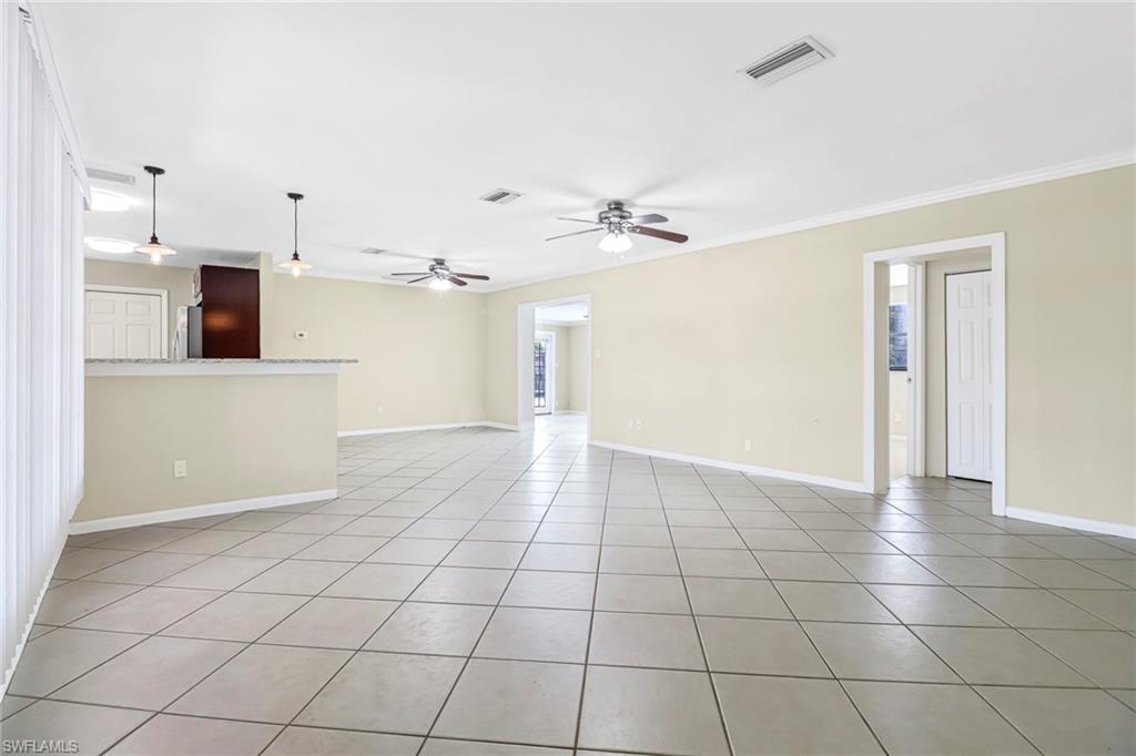 189 Mentor Drive Naples, FL 34110 - Photo 4 of 25 a view of a kitchen with a sink and a refrigerator