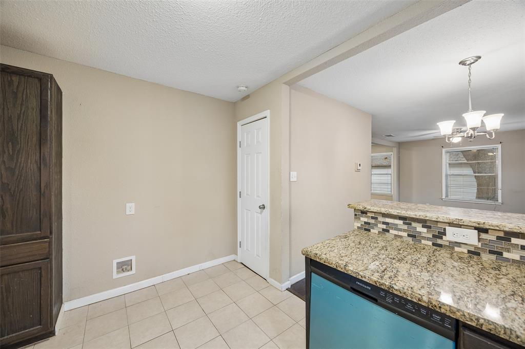 117 Moon Street Cleburne, TX 76033 - Photo 11 of 28 a bathroom with a granite countertop sink and a mirror