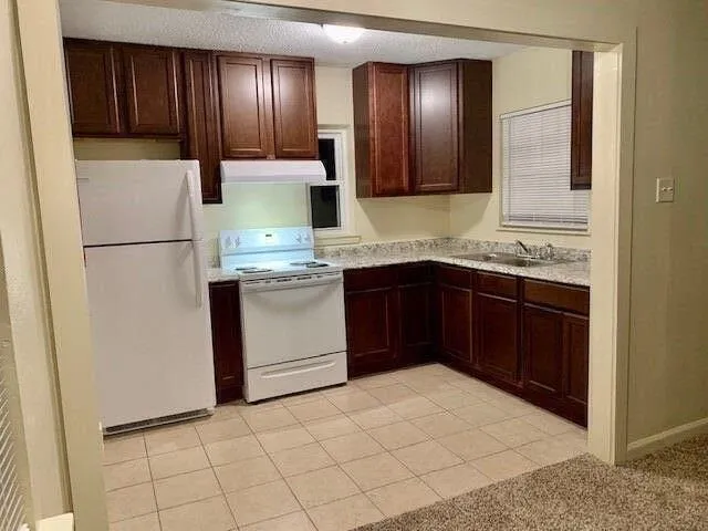 a kitchen with a sink appliances and cabinets