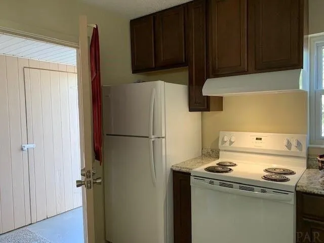 a kitchen with a stove and a refrigerator