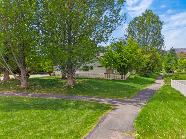 557 Craftsman Way Midway, UT 84049 - Photo 49 of 59 Expansive green lawn featuring mature trees and paved walking paths
