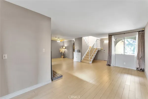 a view of an entryway with wooden floor and a livingroom
