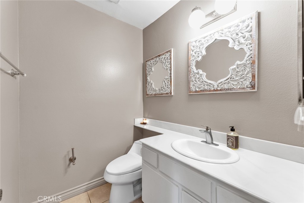 16211 Sierra Ridge Way Hacienda Heights, CA 91745 - Photo 19 of 46 a bathroom with a toilet a sink and mirror