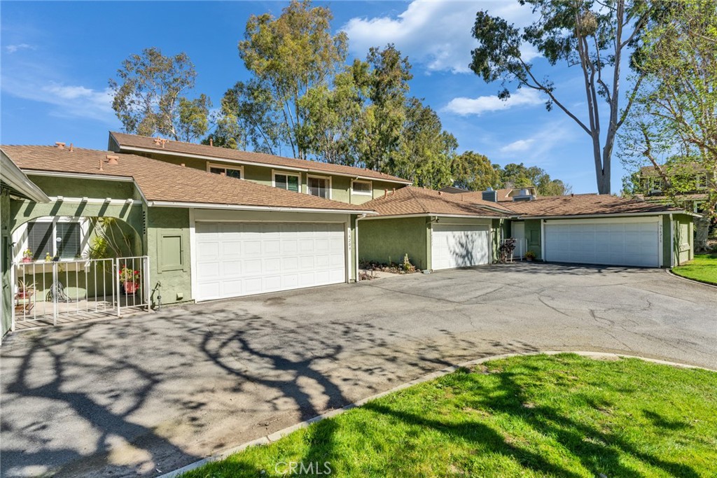 16211 Sierra Ridge Way Hacienda Heights, CA 91745 - Photo 2 of 46 a front view of a house with a yard and a garage