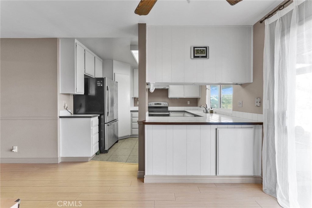 16211 Sierra Ridge Way Hacienda Heights, CA 91745 - Photo 22 of 46 a kitchen with stainless steel appliances a refrigerator sink and microwave