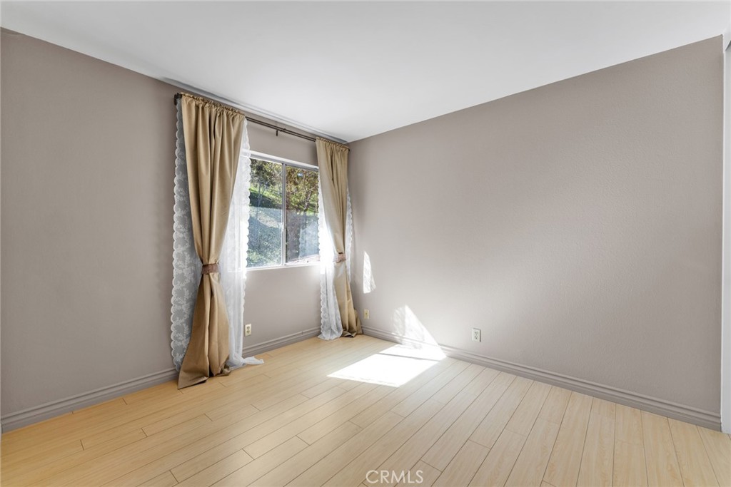 16211 Sierra Ridge Way Hacienda Heights, CA 91745 - Photo 26 of 46 an empty room with wooden floor and windows