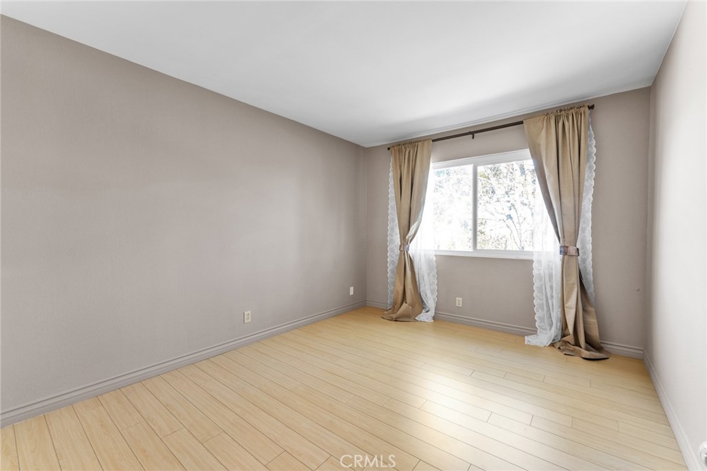 16211 Sierra Ridge Way Hacienda Heights, CA 91745 - Photo 27 of 46 an empty room with wooden floor and windows