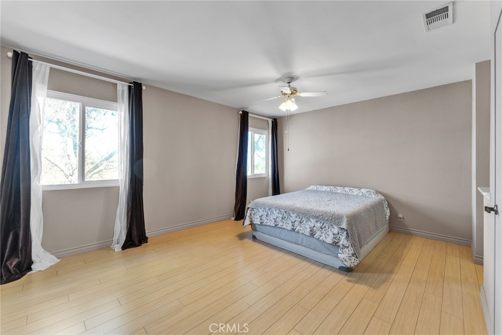 16211 Sierra Ridge Way Hacienda Heights, CA 91745 - Photo 28 of 46 a bedroom with a bed and a chandelier