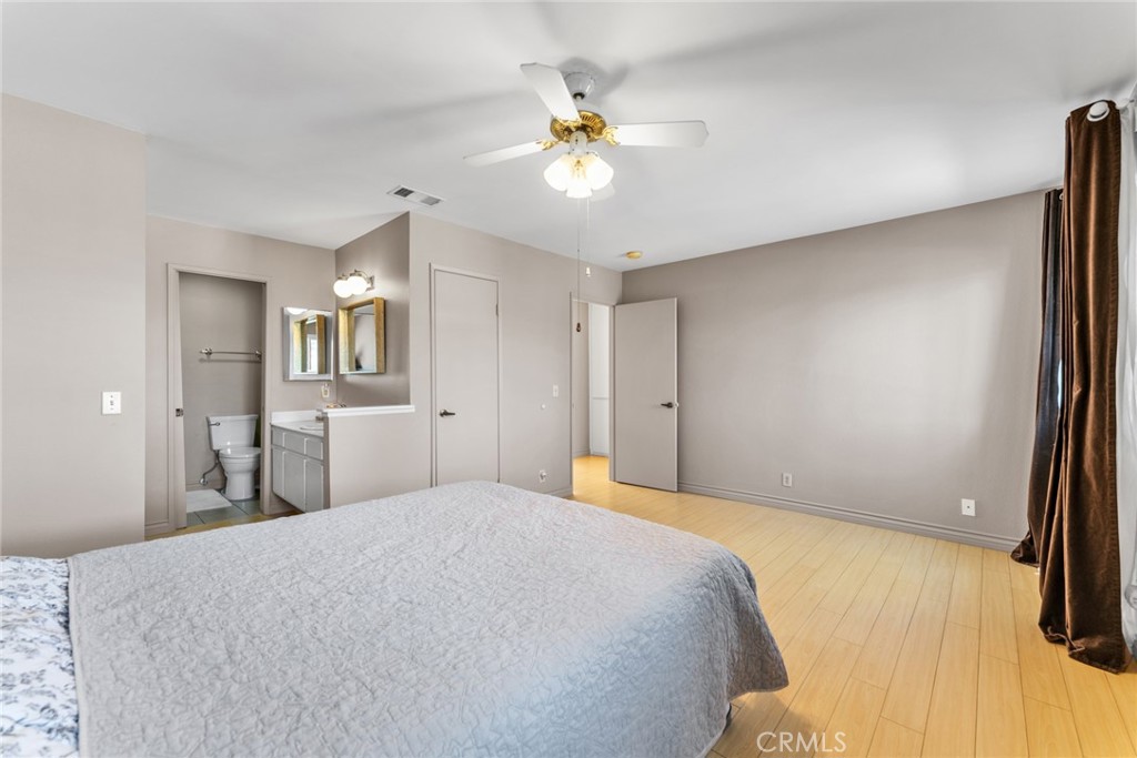16211 Sierra Ridge Way Hacienda Heights, CA 91745 - Photo 29 of 46 a bedroom with a bed and a chandelier