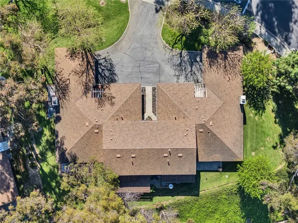 an aerial view of a house with a yard