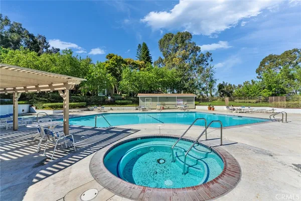 swimming pool view with a garden space