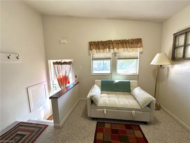 a bedroom with a bed and a large mirror