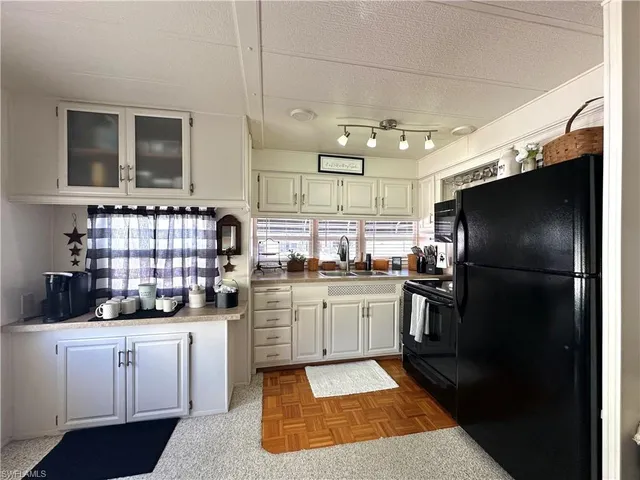 a living room with furniture a clock and white walls