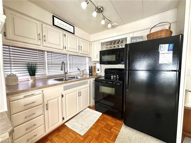 a living room with a couch and a dining table with wooden floor