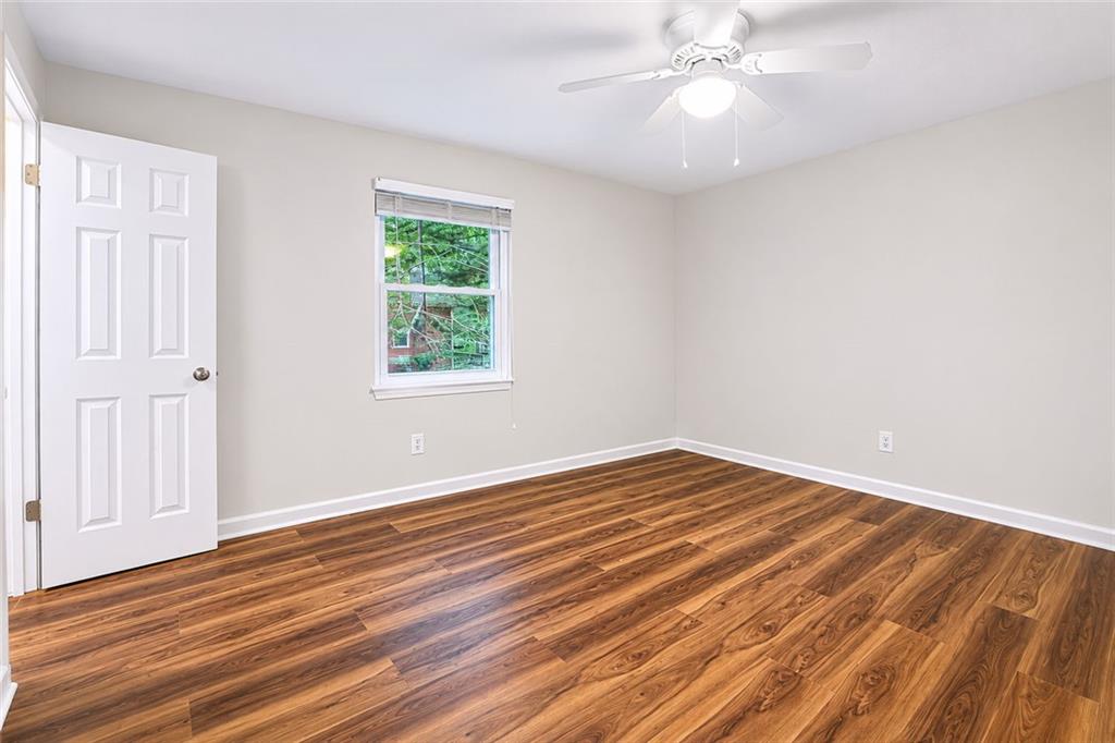 3193 East Point Street, Unit 4 Atlanta, GA 30344 - Photo 13 of 20 wooden floor in an empty room with a window