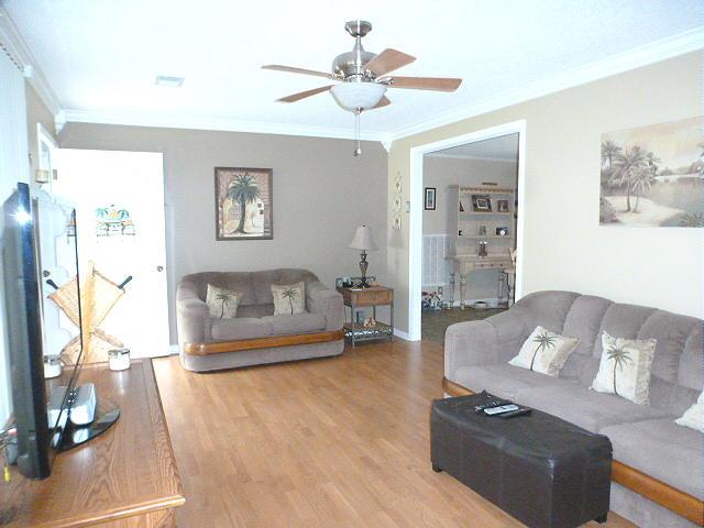 965 Gratton Road Clarksville, TN 37043 - Photo 7 of 21 Living Room with Ceiling Fan,Crown Molding, and Laminate Flooring