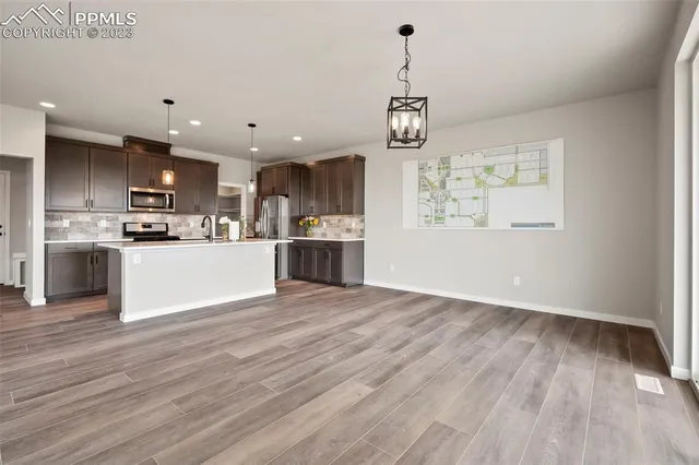 a view of a kitchen with a sink stainless steel appliances and cabinets