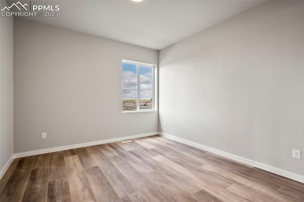 22132 Cattlemen Run Calhan, CO 80808 - Photo 20 of 43 a view of room with window and hardwood floor