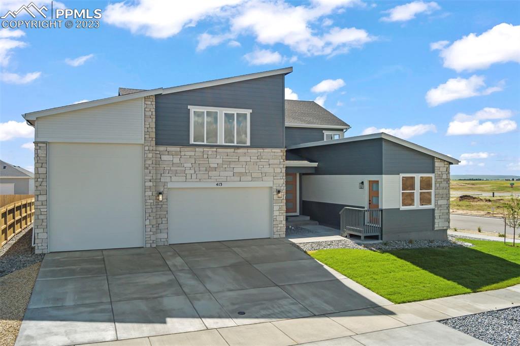 22132 Cattlemen Run Calhan, CO 80808 - Photo 3 of 43 a front view of house with yard