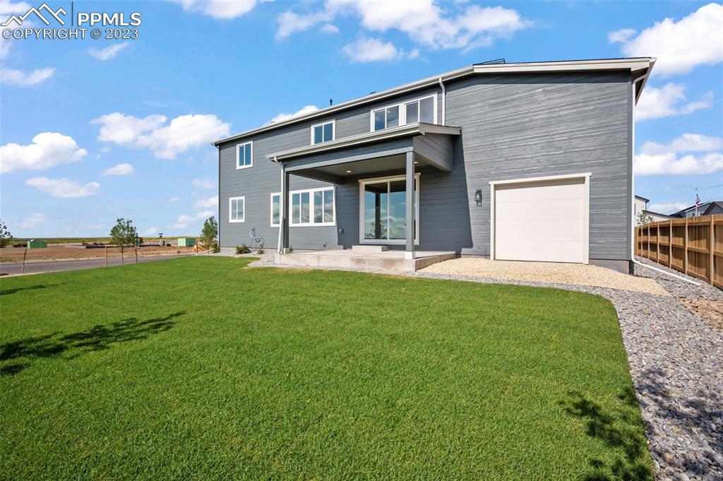 22132 Cattlemen Run Calhan, CO 80808 - Photo 5 of 43 a front view of a house with garden