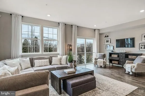 a living room with furniture and large windows