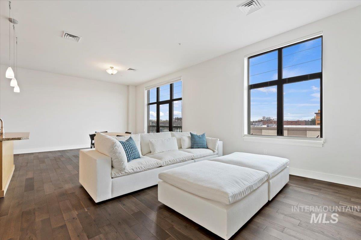 419 South 8th Street, Unit 309 Boise, ID 83702 - Photo 10 of 28 Living area with dark wood-style floors and baseboards