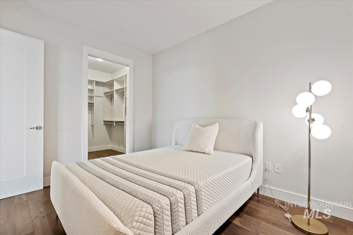 419 South 8th Street, Unit 309 Boise, ID 83702 - Photo 13 of 28 Bedroom with dark wood-type flooring and a spacious closet